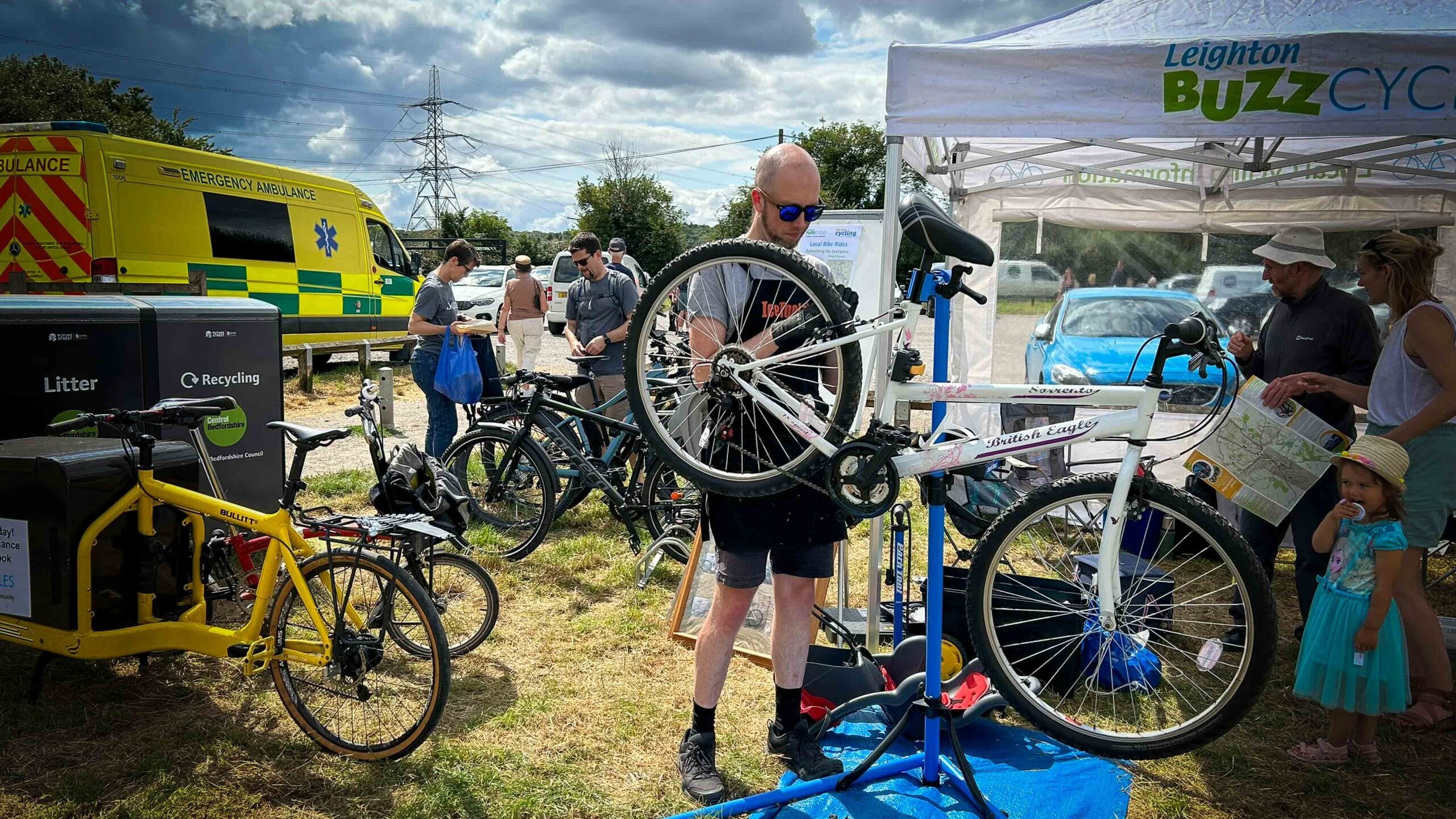 Bicycle on stand with a cyclist working on the bicycle