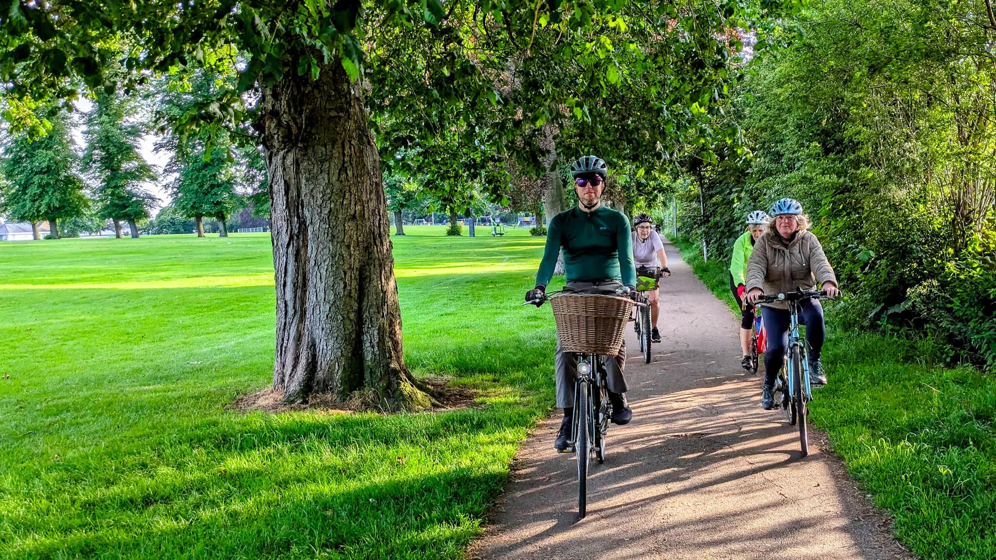 4 cyclist on a park cycleway